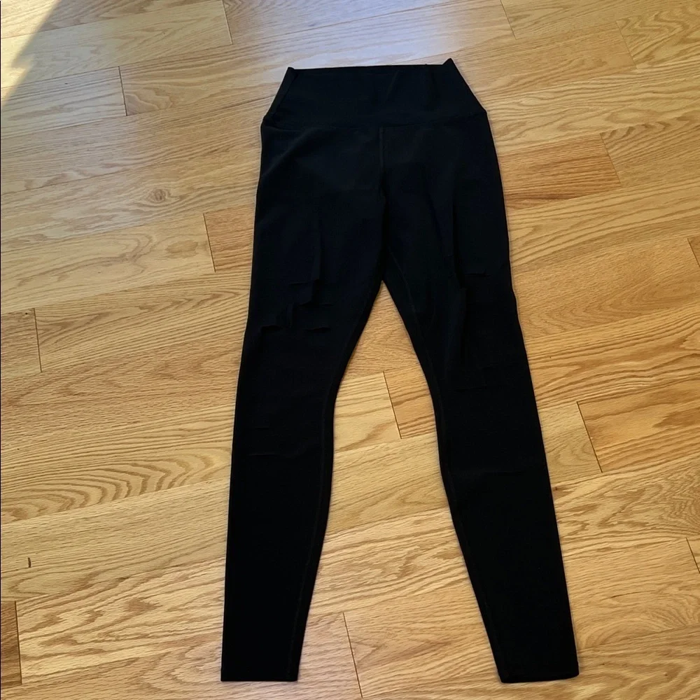 ALO Yoga black ripped high waist warrior leggings.